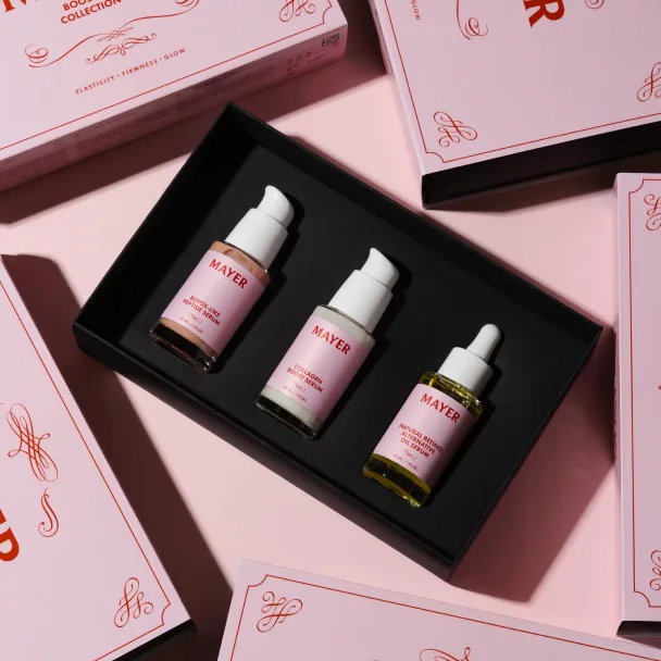 Pink gift box holding three dropper bottles, nestled in pink branded packaging.